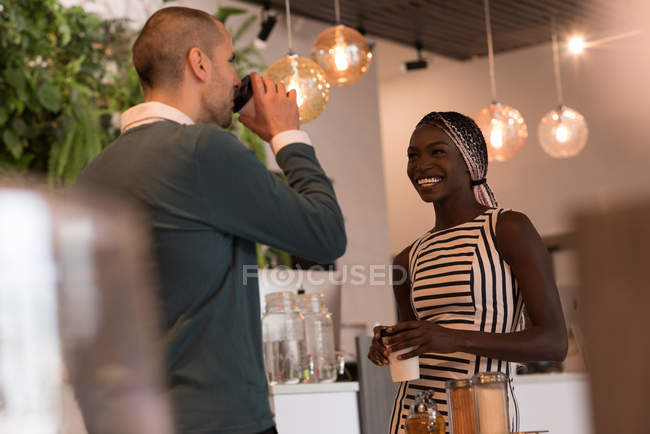 Couple interacting while having coffee in cafe — Stock Photo