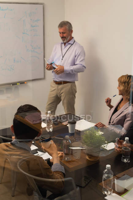 Executives discussing in conference room at office — Stock Photo