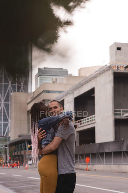 Romantic couple hugging on street in city — Stock Photo