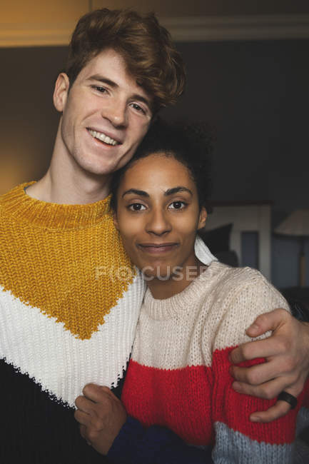 Portrait of couple embracing at home interior — Stock Photo