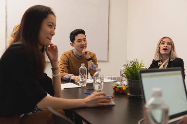 Executives discussing in meeting room at office — Stock Photo