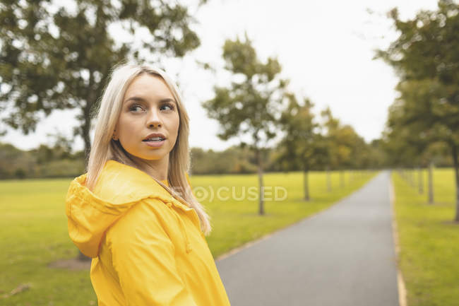 Blonde woman looking away in park — Stock Photo