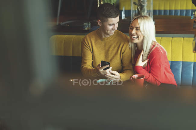 Happy couple having fun in cafe — Stock Photo