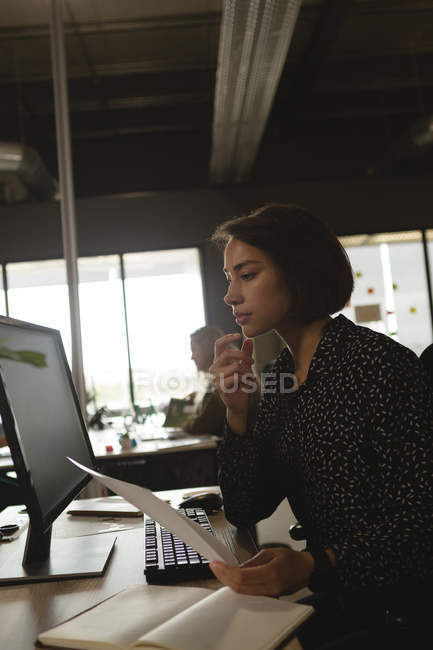 Thoughtful executive working at desk in office — Stock Photo