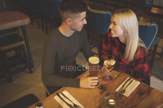 Vue grand angle du couple prenant un verre au restaurant — Photo de stock