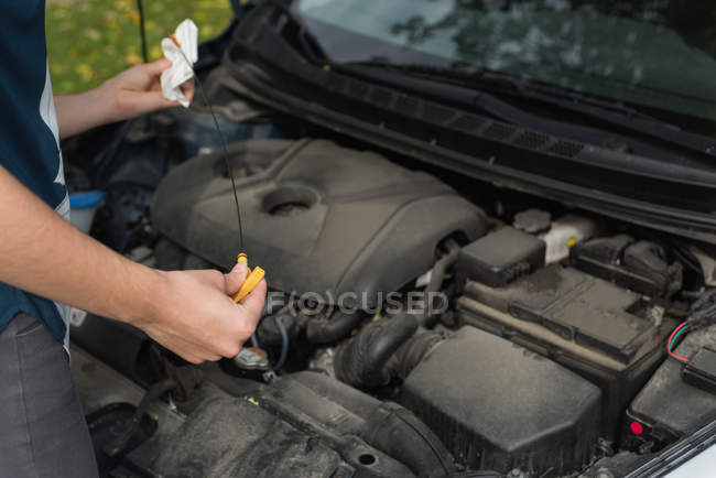 Close-up of woman checking a car during breakdown — Stock Photo