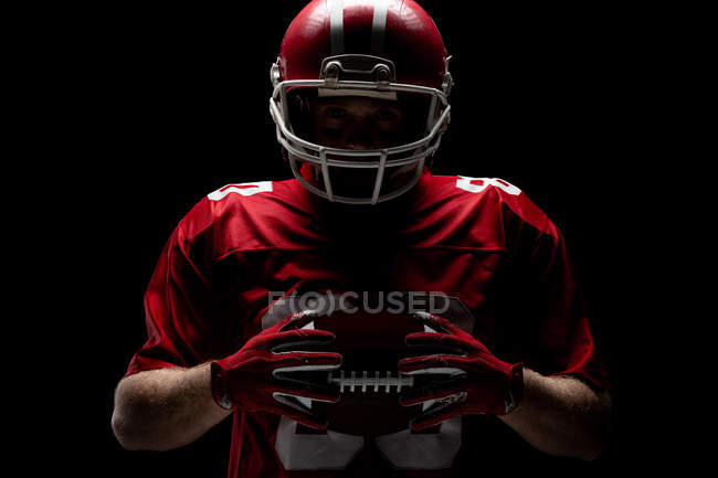 American Football Player Standing With Rugby Helmet And Ball Against Black Background Expertise One Person Stock Photo 224832572