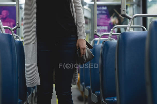 Mid section of woman travelling in train — Stock Photo