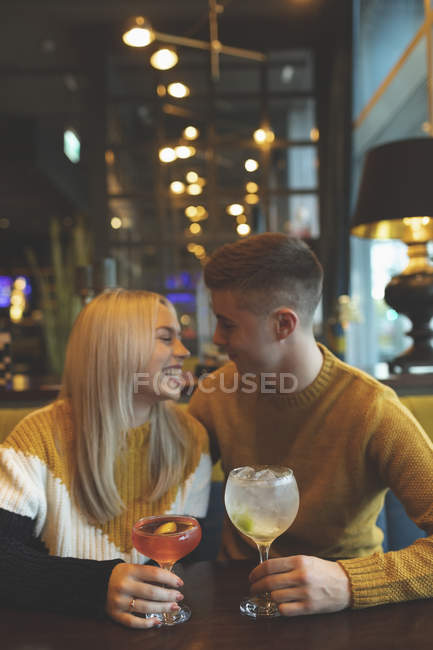 Happy couple having drinks in restaurant — Stock Photo