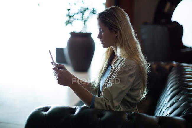 Beautiful woman using digital tablet in waiting area at airport terminal — Stock Photo