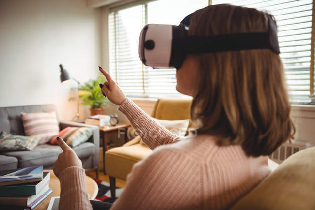 Donna che utilizza occhiali auricolari realtà virtuale a casa — Foto stock
