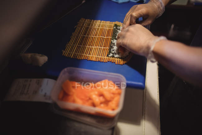 Nahaufnahme der Hände des Küchenchefs bei der Zubereitung von Sushi im Restaurant — Stockfoto