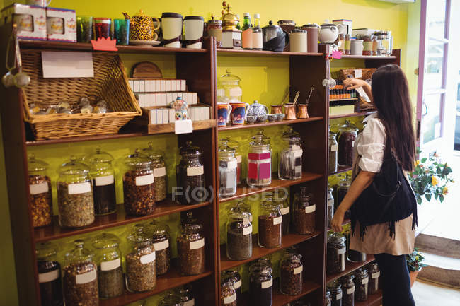 Woman selecting box containing sweets in shop — Stock Photo