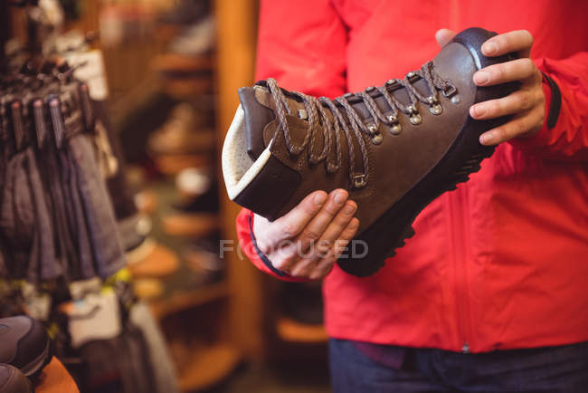 Primer plano del hombre que selecciona el zapato en una tienda - foto de stock