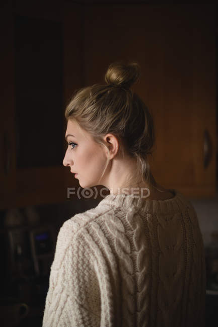 Thoughtful woman in kitchen at home — Stock Photo
