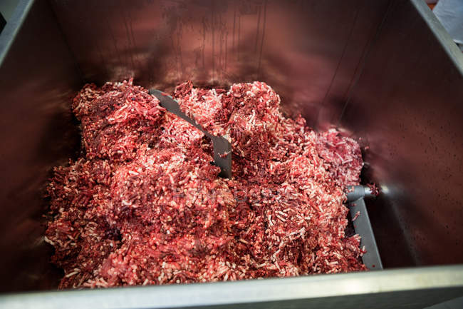 Close-up of meat mincing machine at meat factory — Stock Photo
