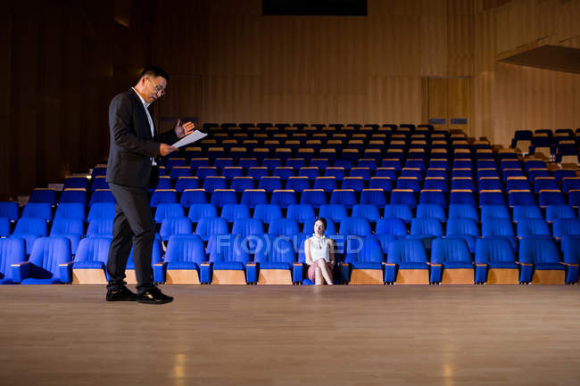 Male business executive practicing speech at conference center — Stock Photo