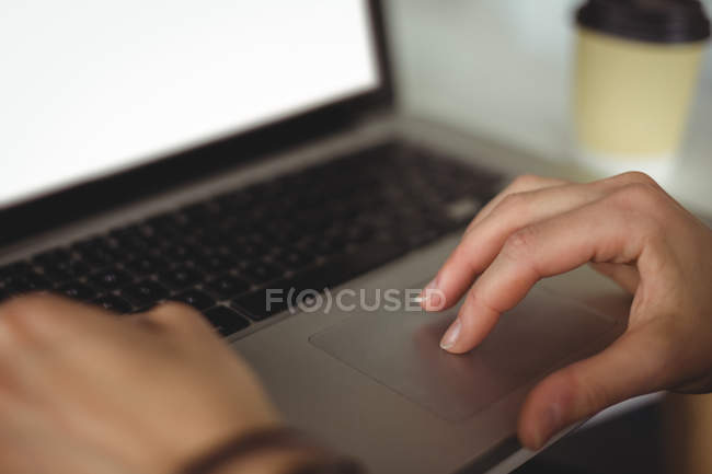 Woman using laptop in cafe — Stock Photo