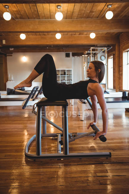 Determined woman practicing pilates in fitness studio — Stock Photo