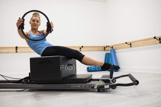 Mulher adulta média exercitando com anel pilates no ginásio — Fotografia de Stock