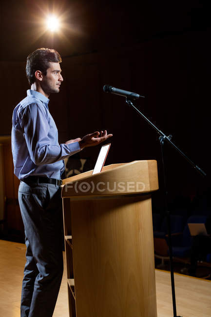 Male business executive giving a speech at conference center — Stock Photo