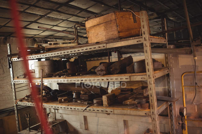 Stampi metallici per la soffiatura del vetro disposti su scaffale presso la fabbrica di soffiaggio del vetro — Foto stock