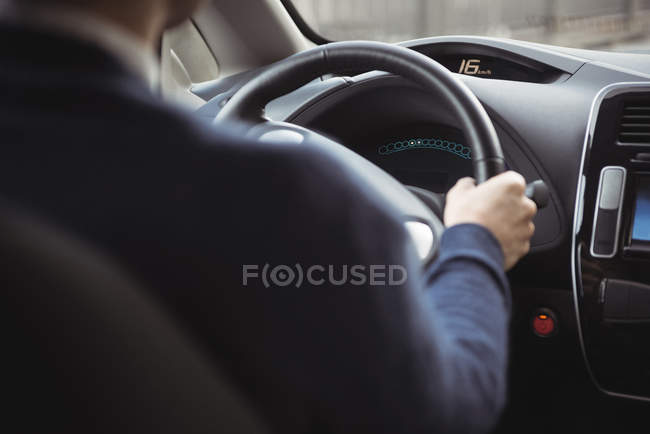 Close-up of man driving electric car — Stock Photo