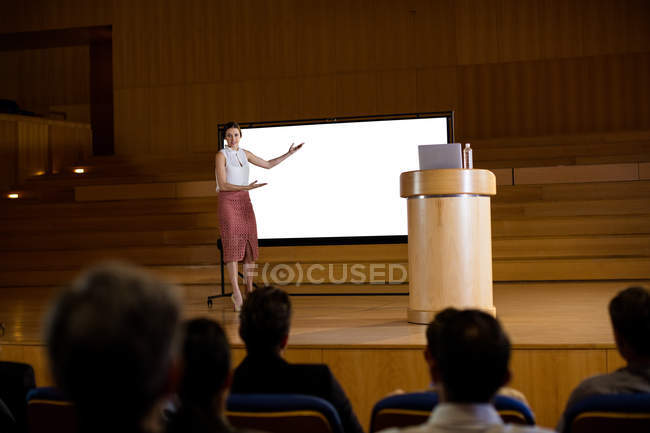 Female business executive giving presentation at conference center — Stock Photo