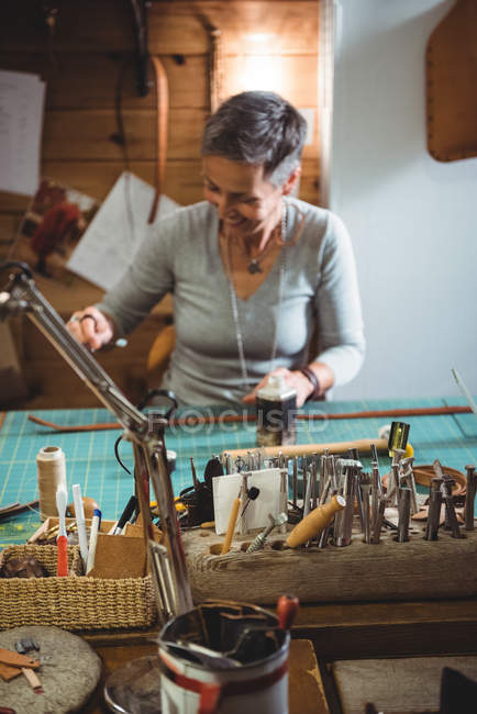 Aufmerksame Handwerkerin bei der Arbeit im Werkstattinnenraum — Stockfoto