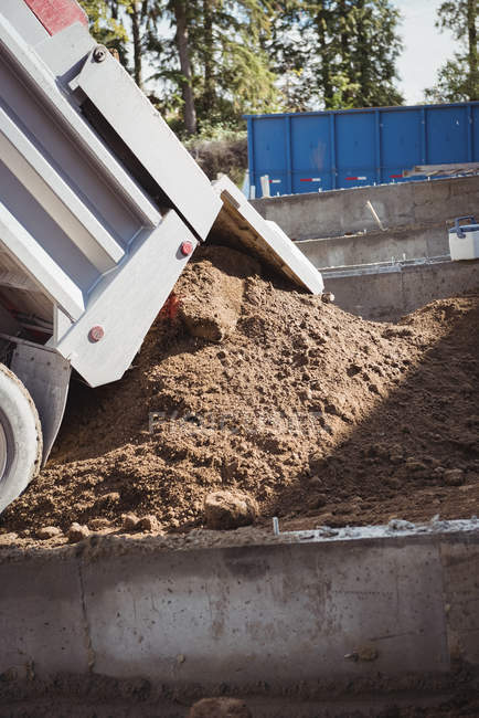 Close-up of dumper unloading mud at construction site — Stock Photo