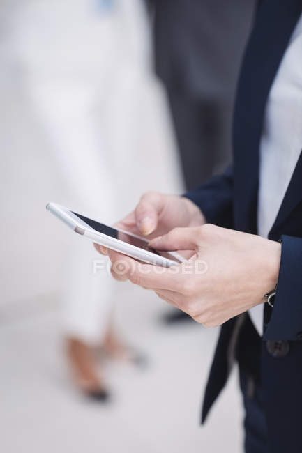 Close-up of a businesswoman using on mobile phone — Stock Photo
