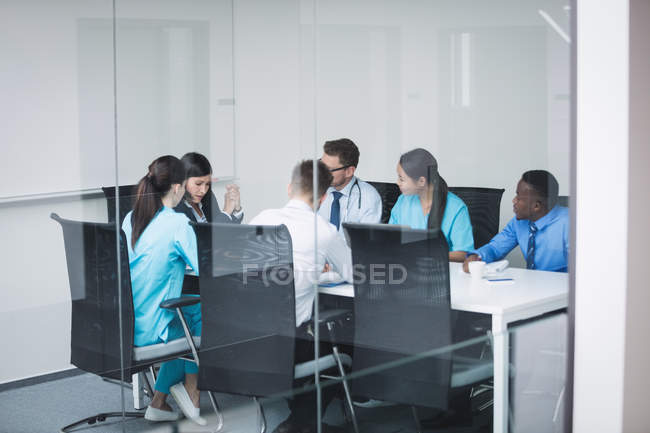 Equipo de médicos en una reunión en la sala de conferencias - foto de stock