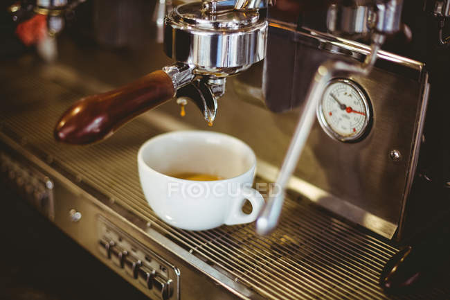 Крупним планом еспресо, що ллється з кавоварки в кафе — стокове фото