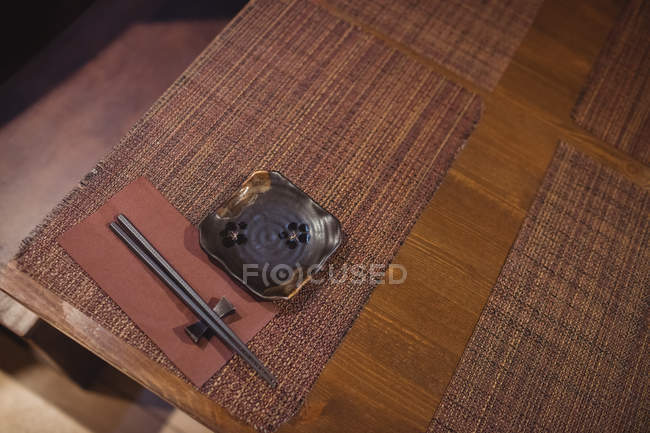 Close-up of chopsticks on dining table in restaurant — Stock Photo