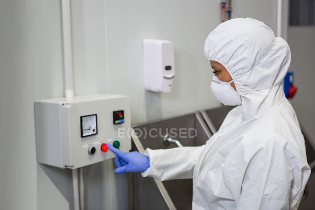 Technician operating machine at industrial meat factory — Stock Photo