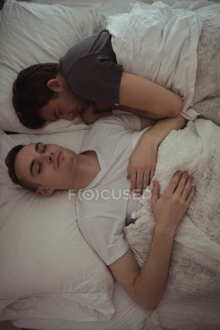 Alto ângulo vista de gay casal dormindo juntos no o cama — Fotografia de Stock
