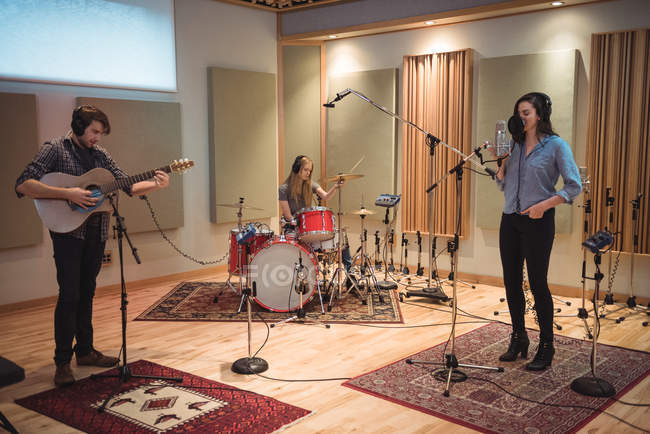 Music band performing in music studio — Stock Photo