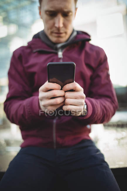Young casual man using mobile phone — Stock Photo