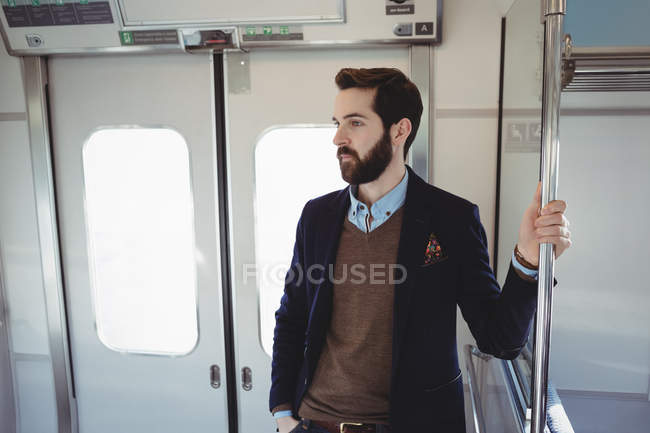 Young businessman travelling in train — Stock Photo