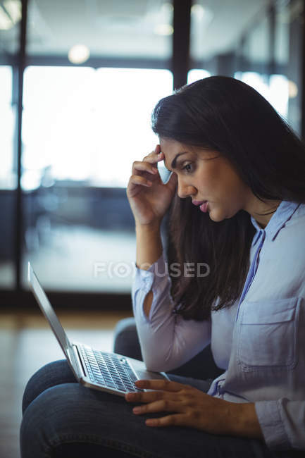 Donna d'affari che lavora sopra computer portatile in ufficio — Foto stock