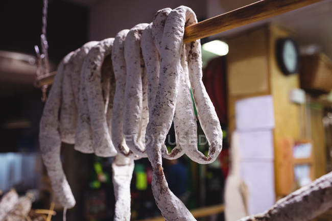 Salsicce che consegnano al bancone della carne nel supermercato — Foto stock