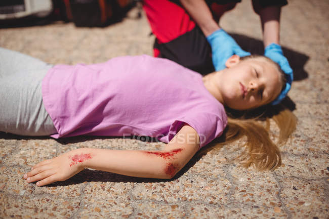 Nahaufnahme von bewusstlosem Mädchen, das nach Unfall am Boden liegt — Stockfoto