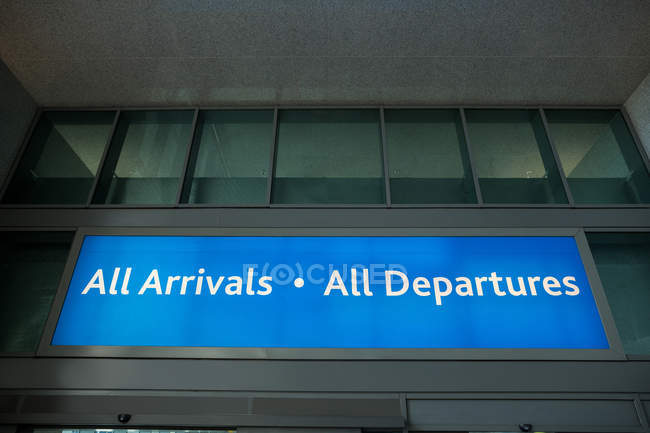 Departure and arrival information board sign at airport — Stock Photo