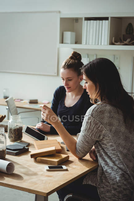Business executives discussing over digital tablet in office — Stock Photo