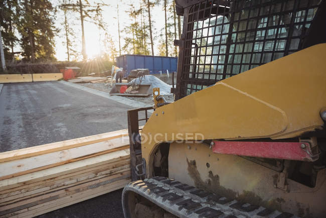 Bulldozer with timbers at construction site — Stock Photo