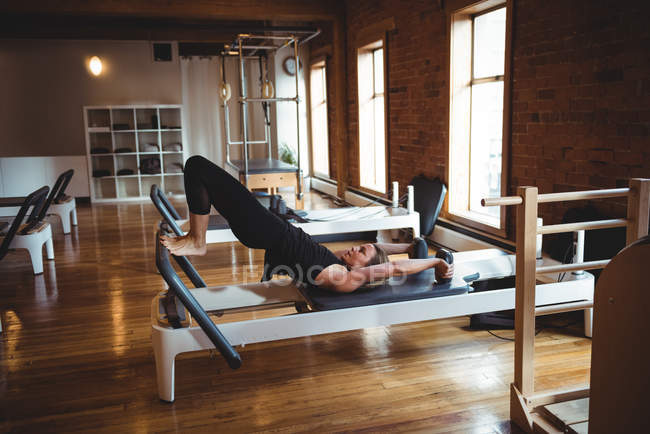 Sporty woman practicing pilates in fitness studio — Stock Photo