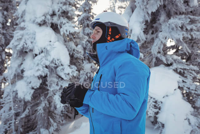 Skier with binocular looking at a distance on snowy mountain — Stock Photo