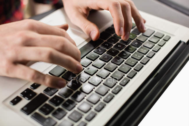 Hands of man using laptop, close-up — Stock Photo