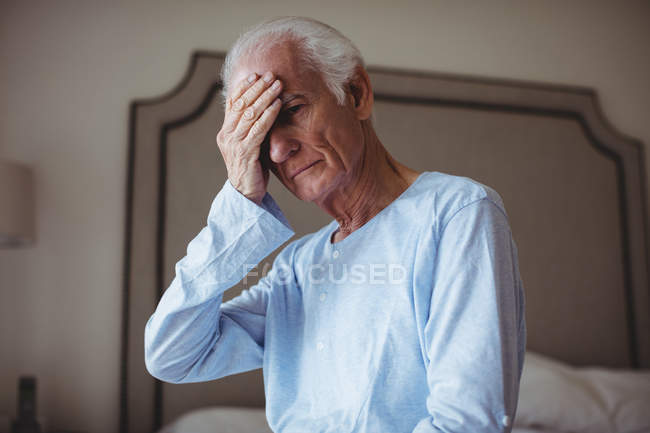 Worried senior man in bedroom at home — Stock Photo