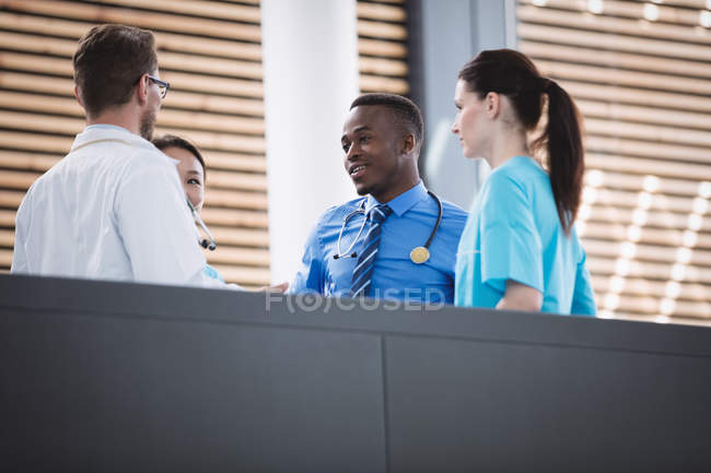 Doctors and nurse interacting with each other in hospital — Stock Photo